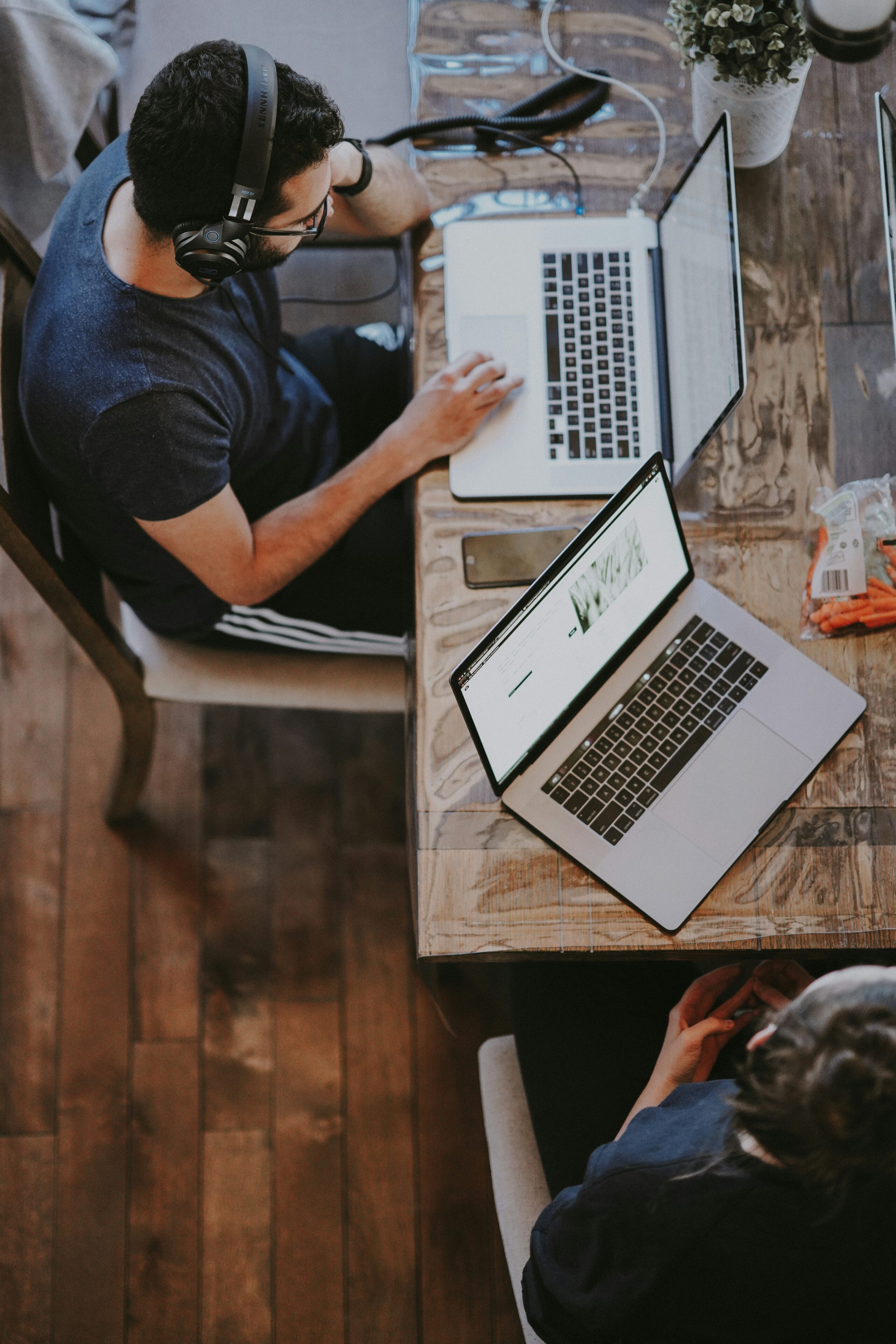 two people in working on laptop